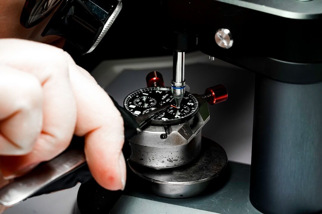 Watchmaker's hands assembling a mechanical watch movement with fine tools