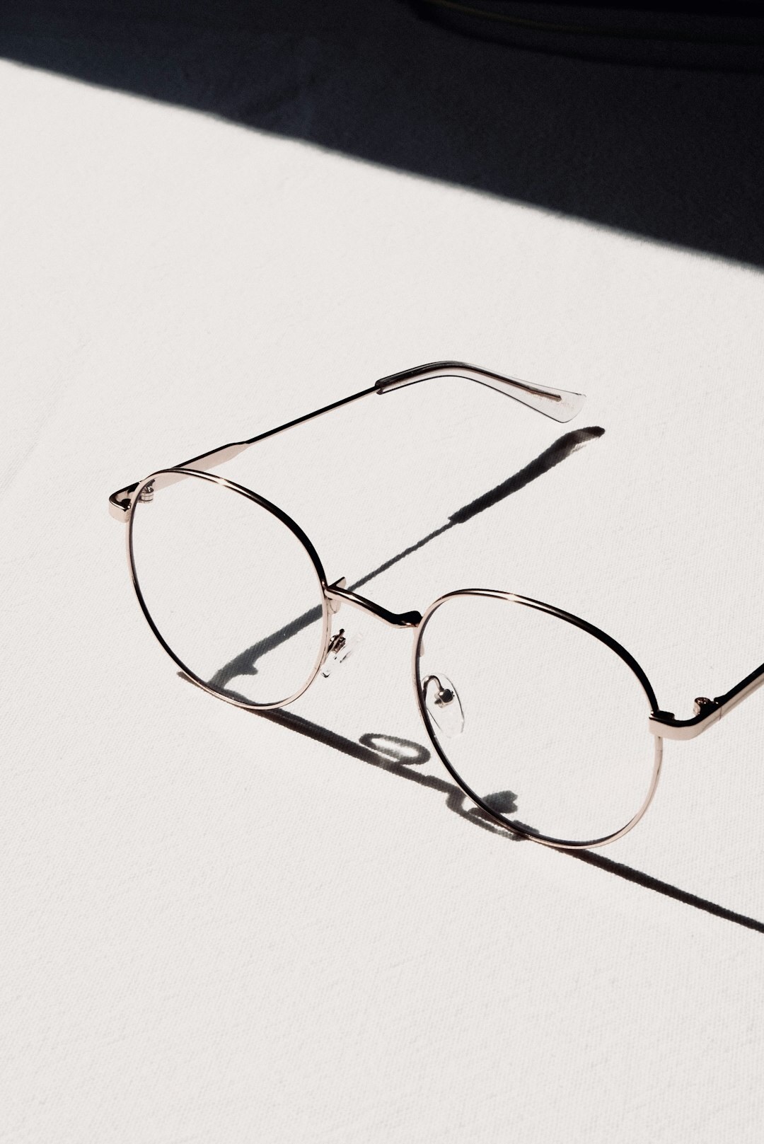 Premium optical eyeglasses frame with thin metal rims on white surface