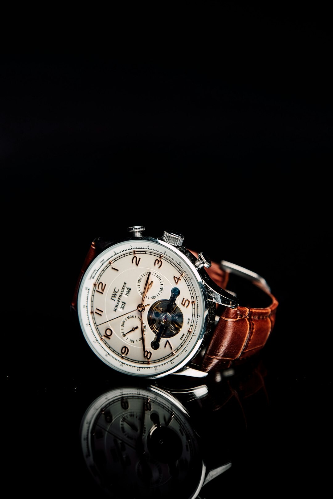 Elegant luxury wristwatch with complications displayed on a dark velvet surface