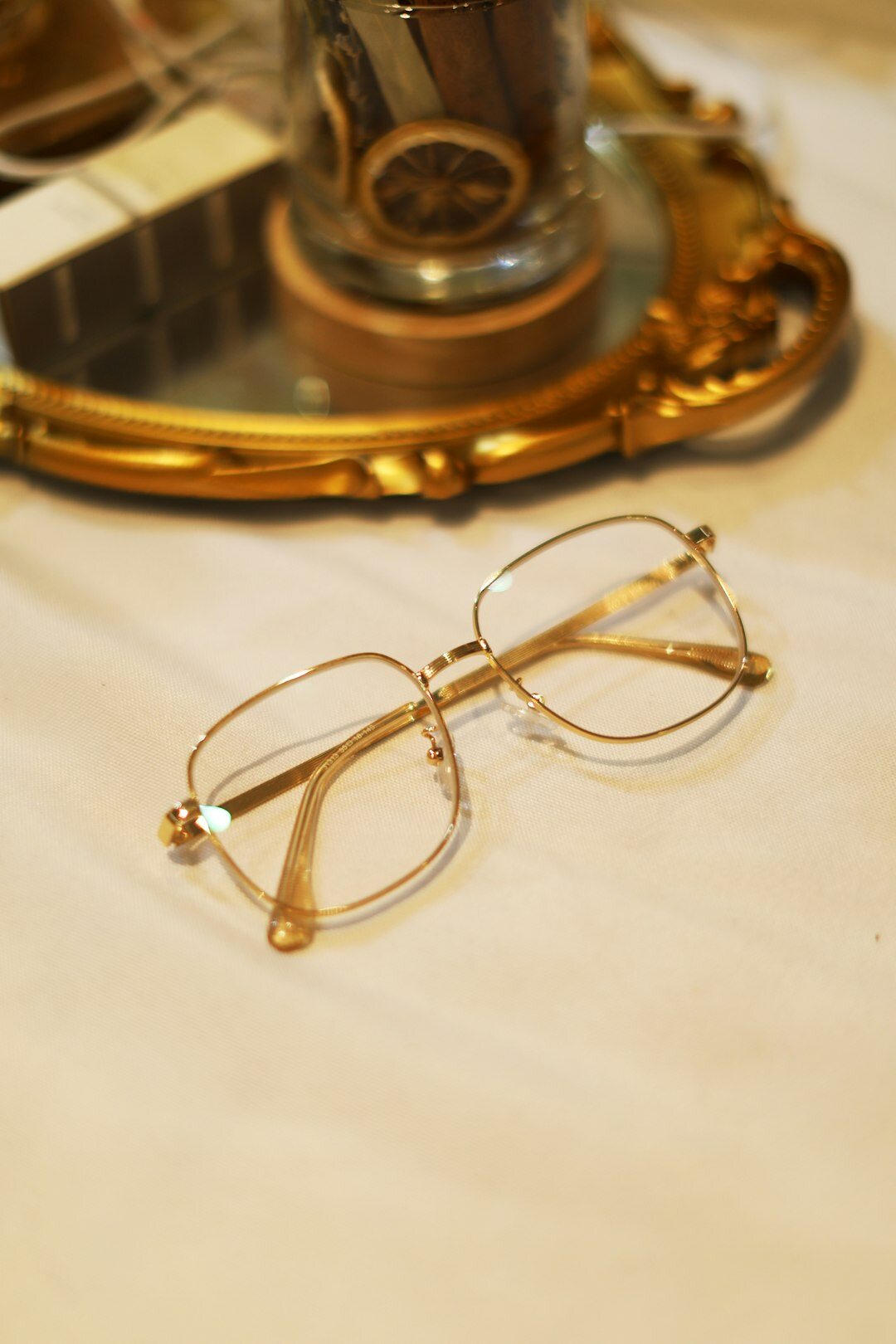 Solid gold eyeglasses frame with subtle gem inlays on velvet