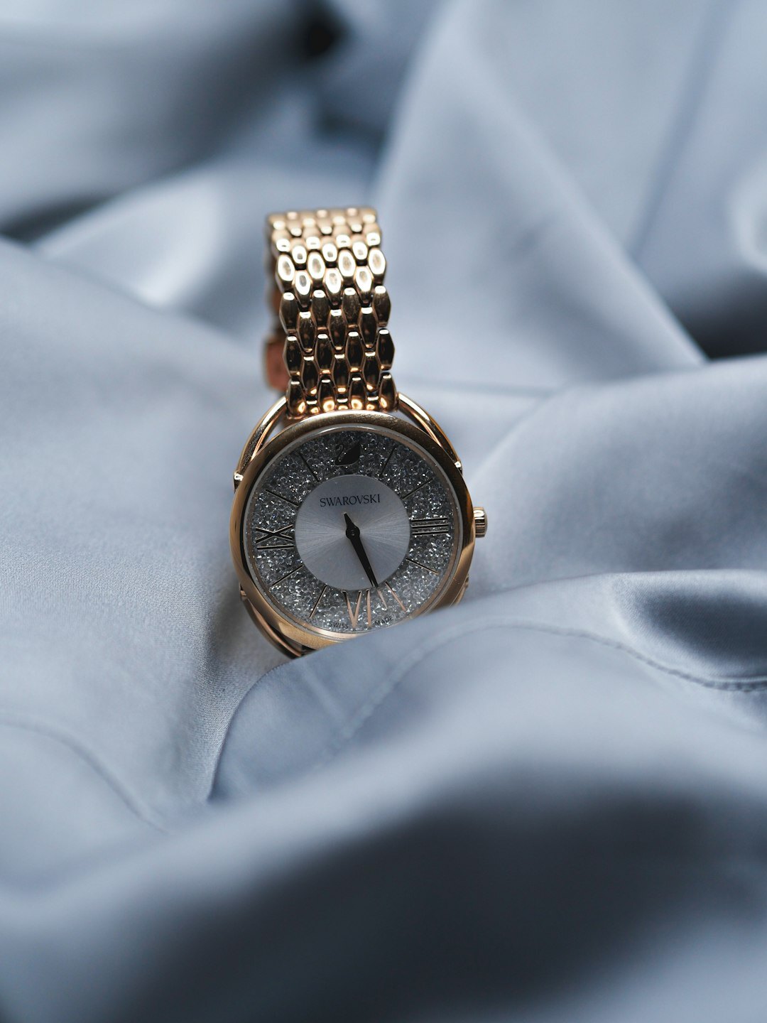 Fully gem-set luxury watch encrusted with diamonds on dark velvet
