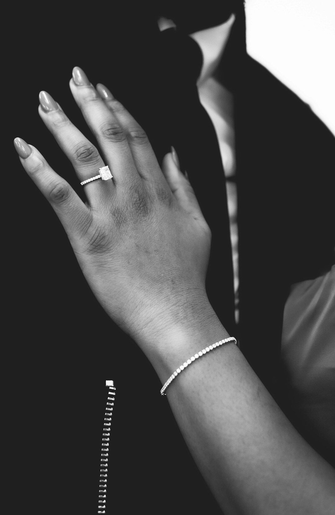 Elegant woman's wrist wearing a diamond jewelry watch and bracelet