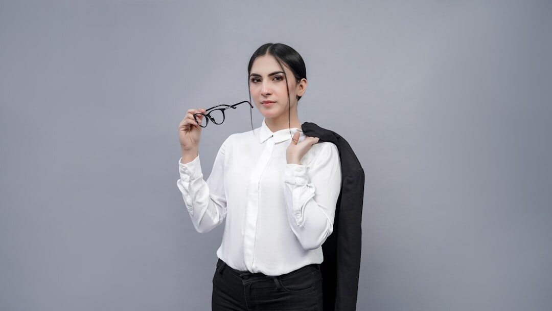 Studio portrait of a professional mature woman optometrist in elegant attire